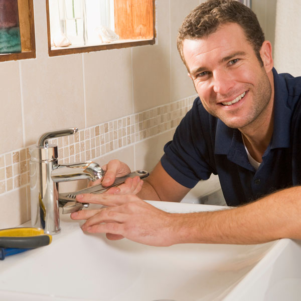 Coblentz Plumber working on a sink faucet